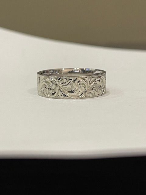 Silver ring with floral engraving.