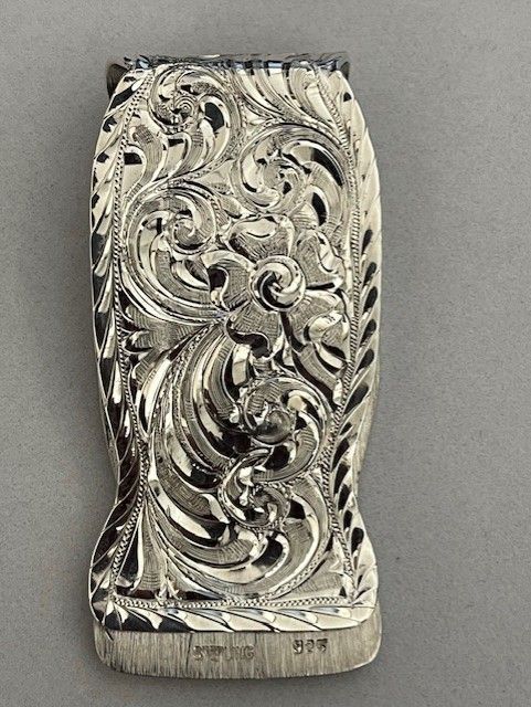 Silver, engraved floral belt buckle.