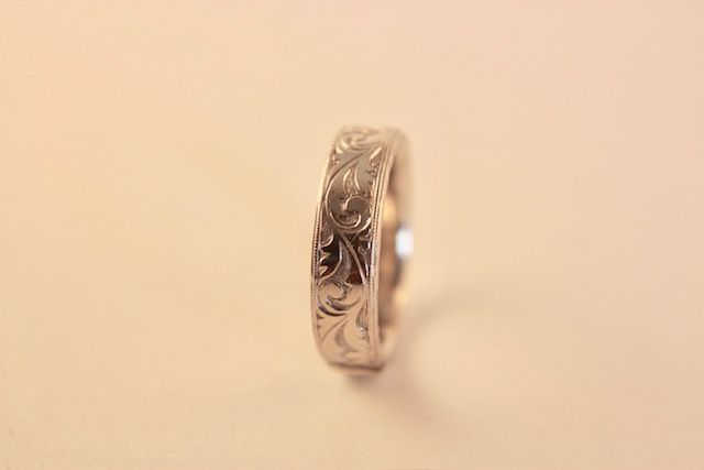 Silver ring with engraved floral design.
