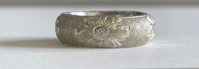 Silver ring with floral design.