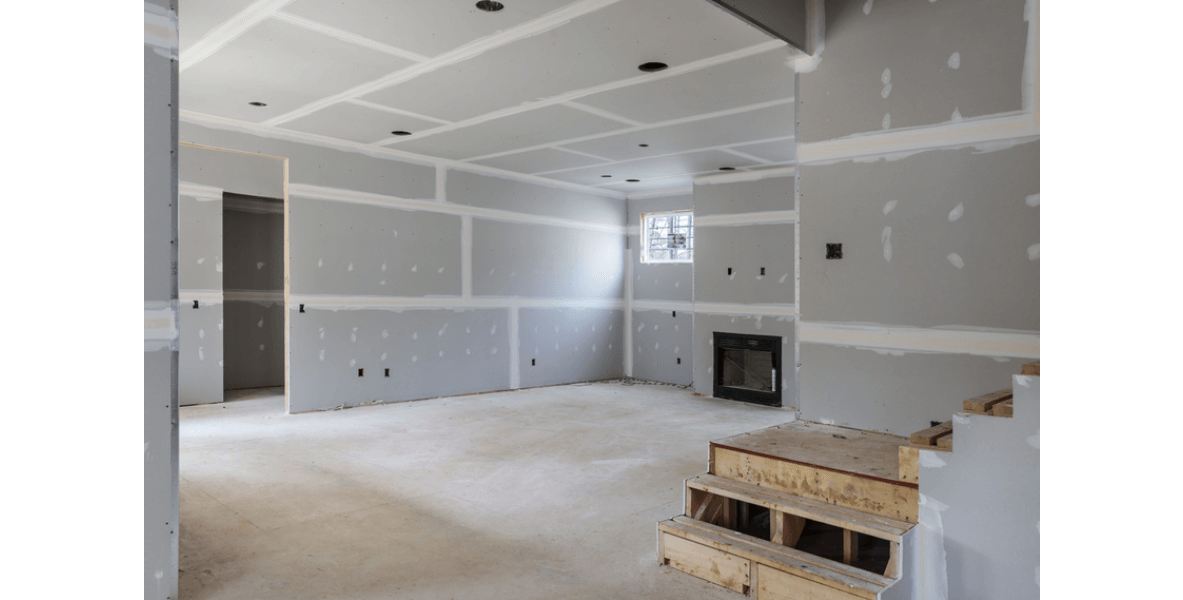 basement with steps a window and fireplace being built