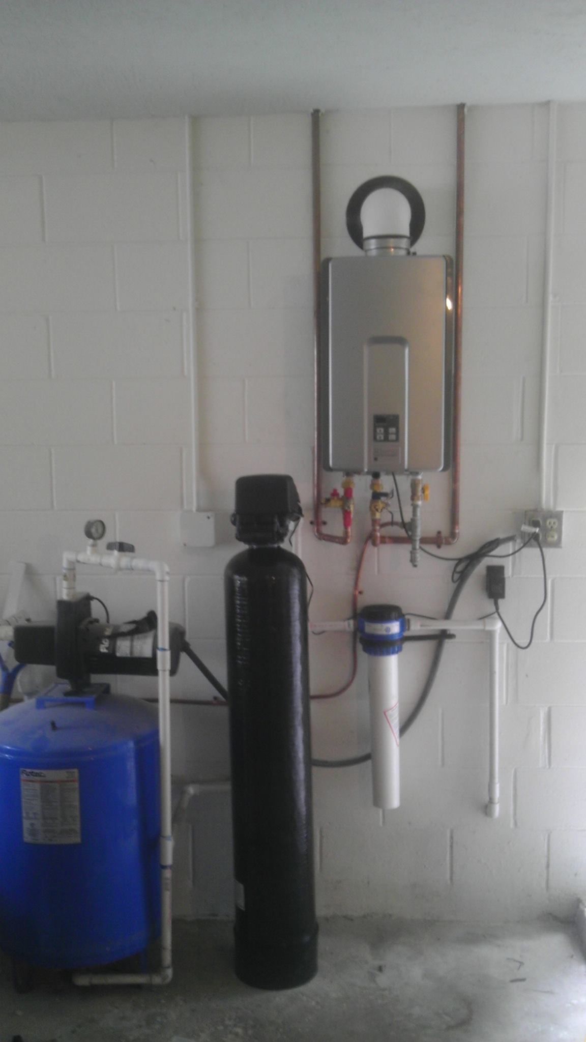 There is a water heater and a water filter in the room.
