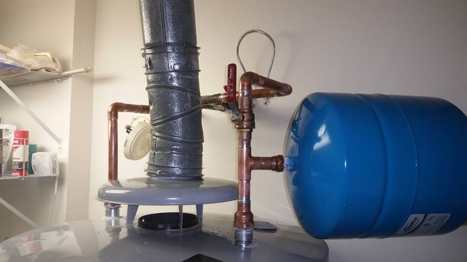 A water heater with a blue tank attached to it.