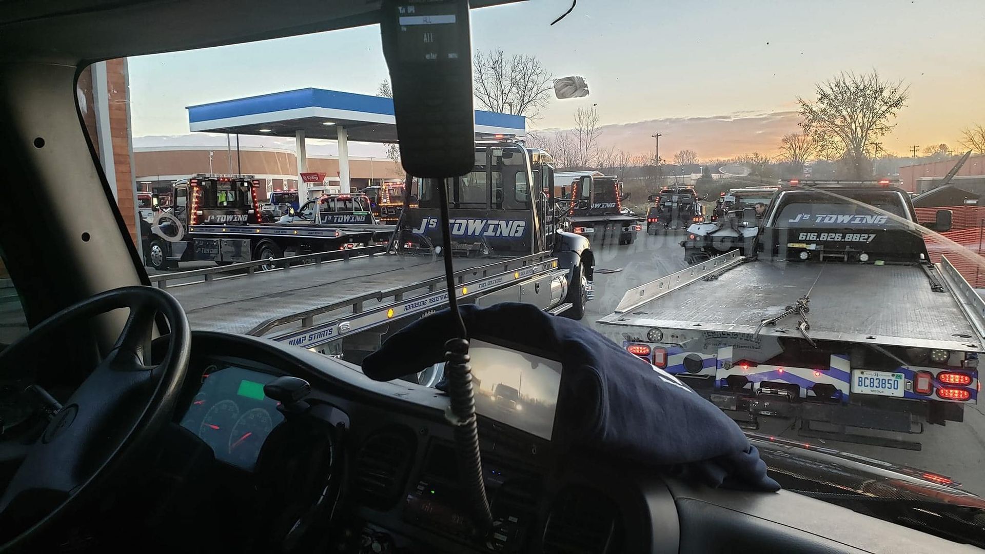 The inside of a truck with a tow truck in the background.