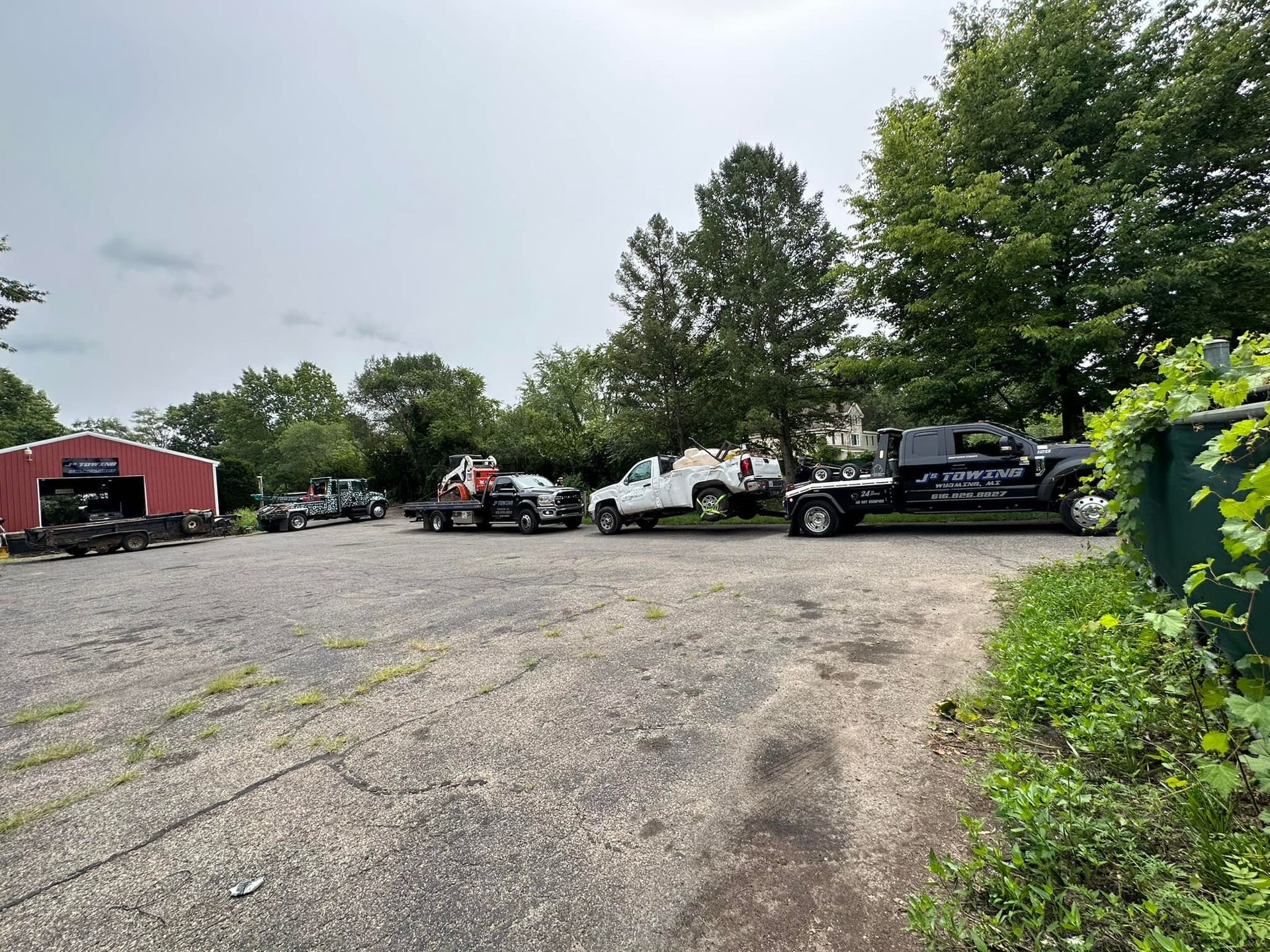 A row of trucks are parked in a parking lot.