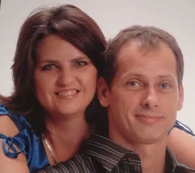 a man and a woman are posing for a picture together .