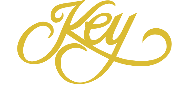 Stylized gold script logo reading &ldquo;Key&rdquo; on a white background