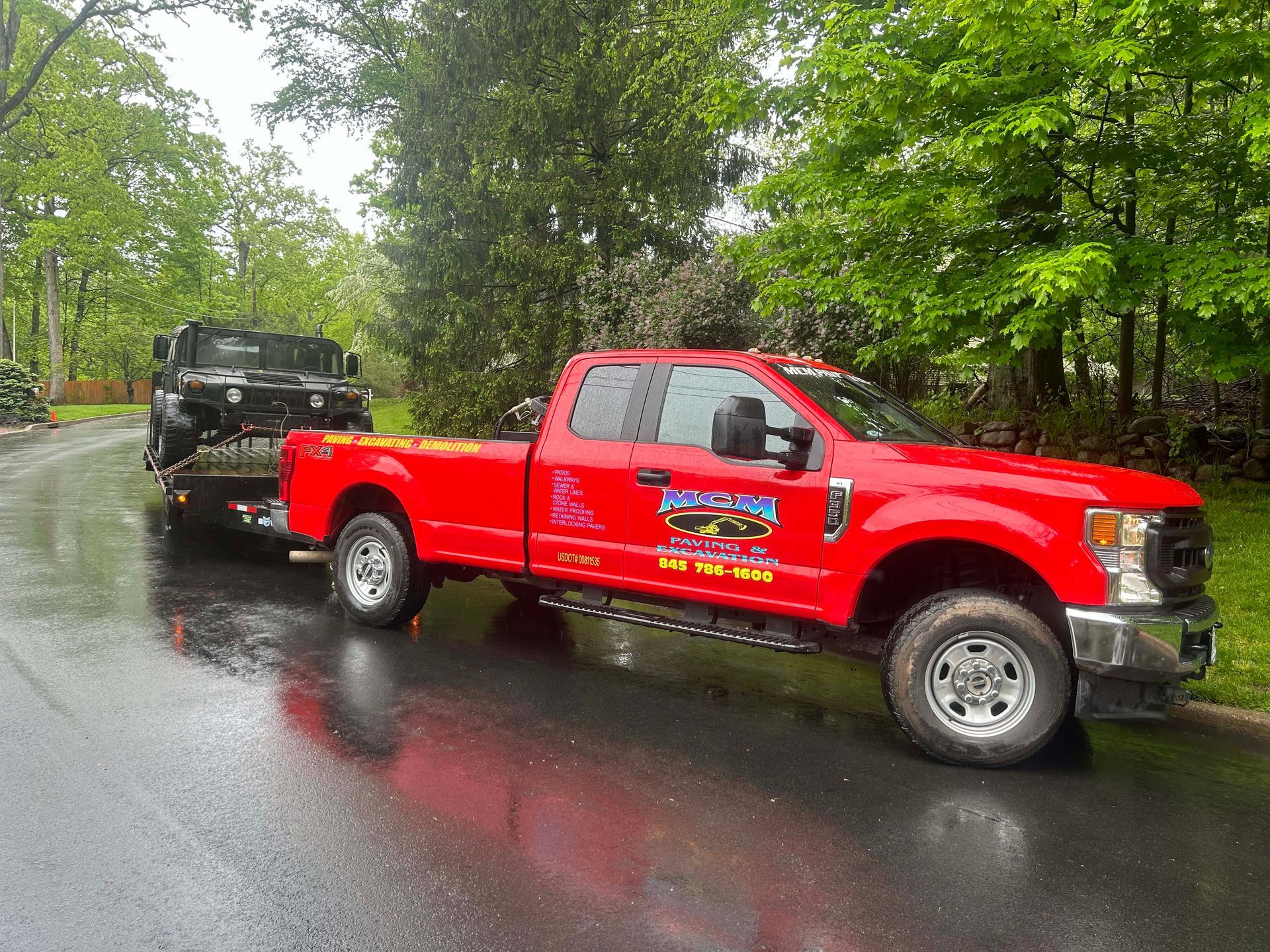 A red tow truck is parked on the side of the road.