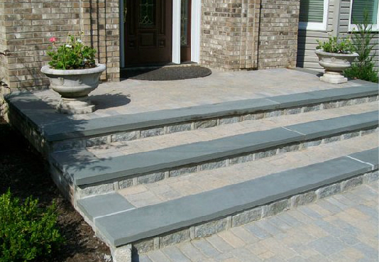 A set of stairs leading up to a brick house.