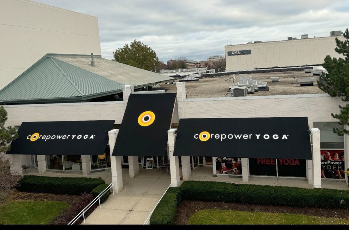 A storefront with black awnings