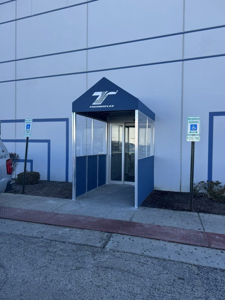 Blue and white entrance awning with the logo