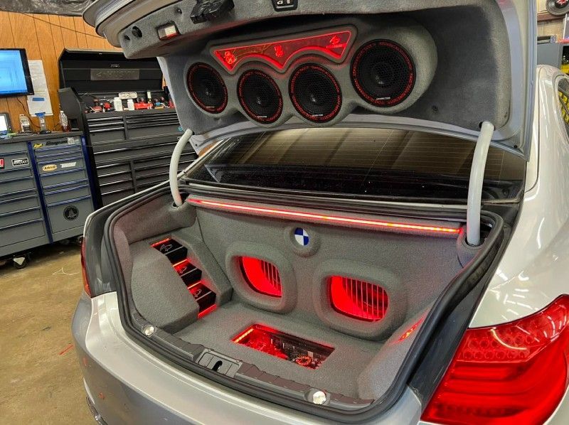 The trunk of a car with a lot of speakers in it.