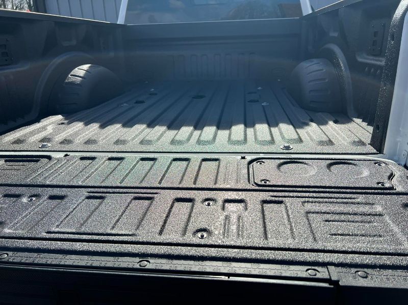 The back of a truck is painted black and has the word zanzibar on it