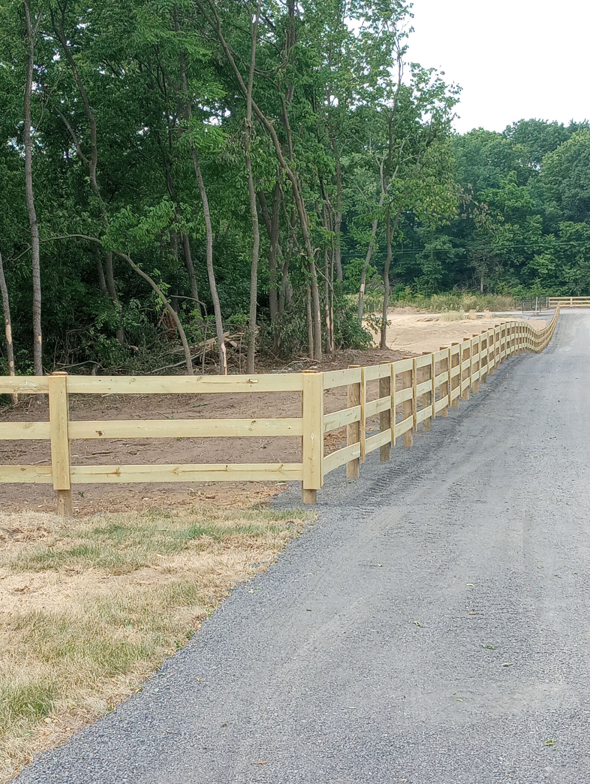 3 board and post wooden fence installed by agricultural fence companies near me