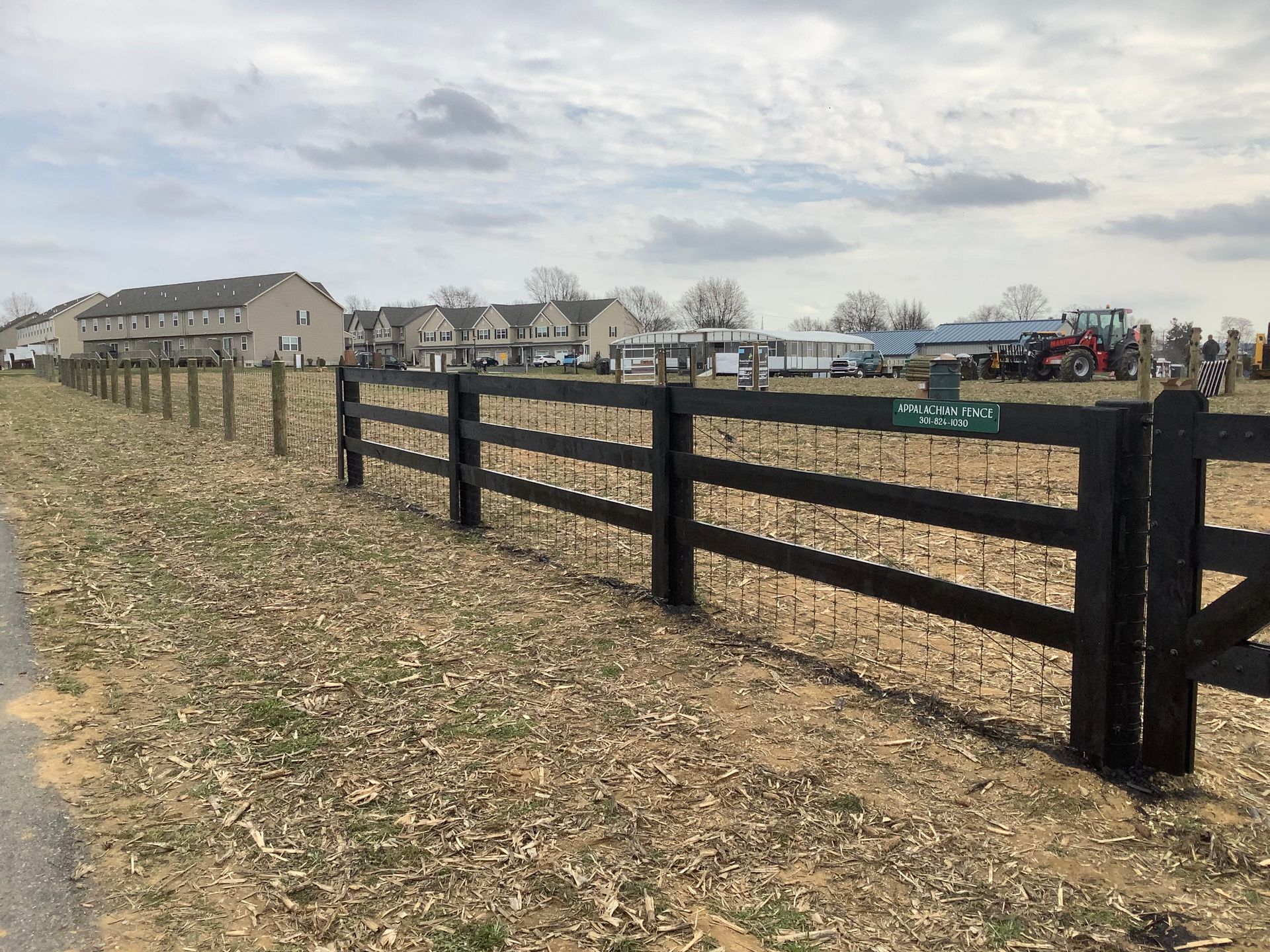 dark brown wooden fence installed by agricultural fencing contractors near me