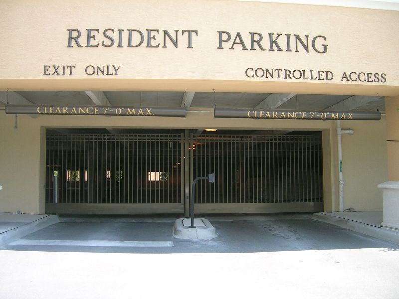 A gated entrance to a resident parking garage