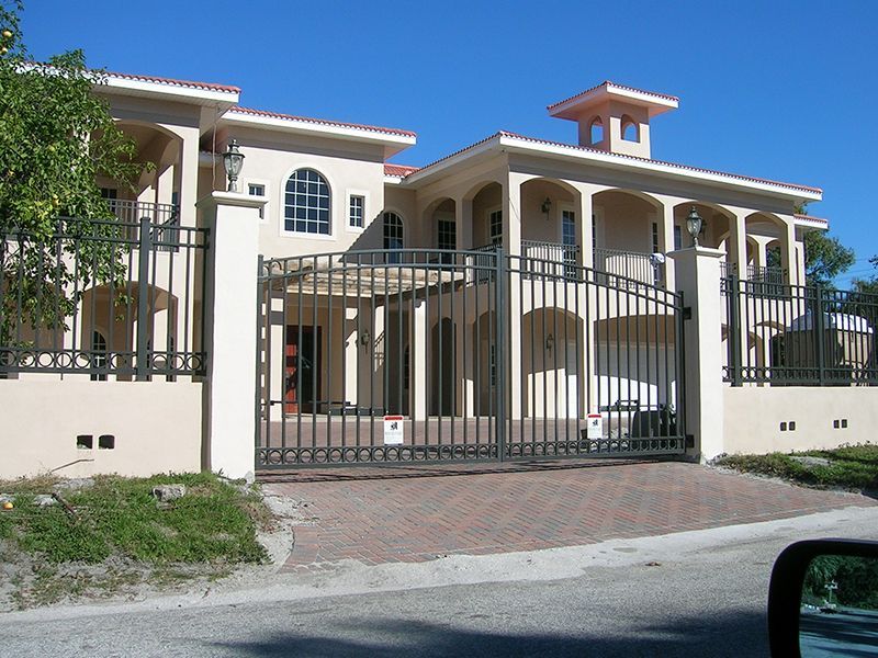 A large white house with a black gate in front of it