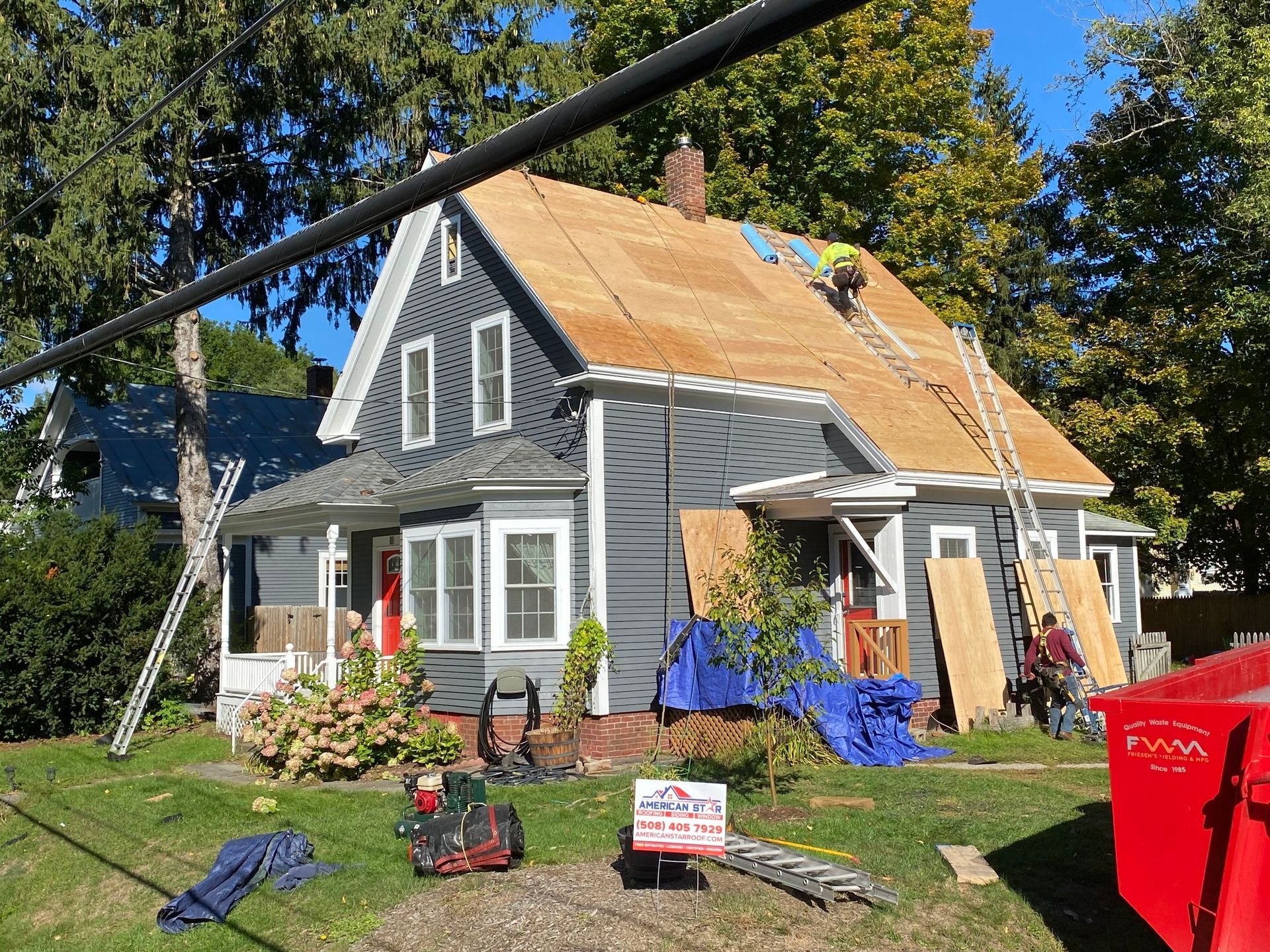 A house is being remodeled with a roof being installed.