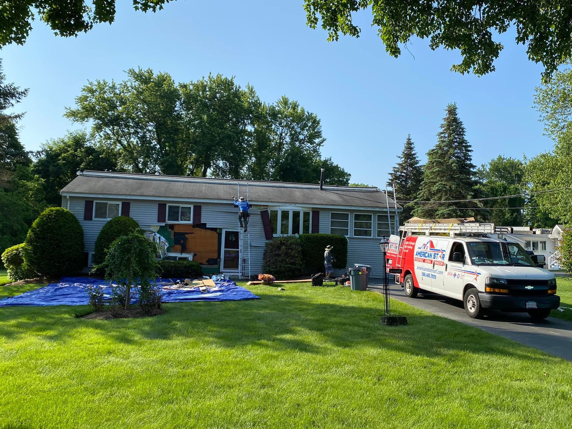 A white van is parked in front of a house.