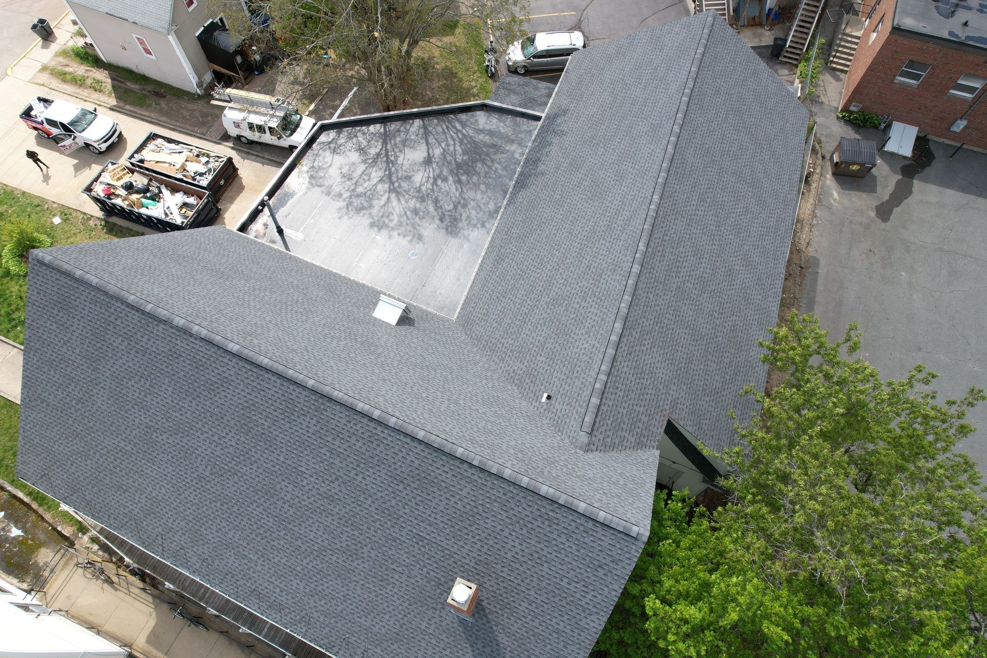 An aerial view of a house with a gray roof.