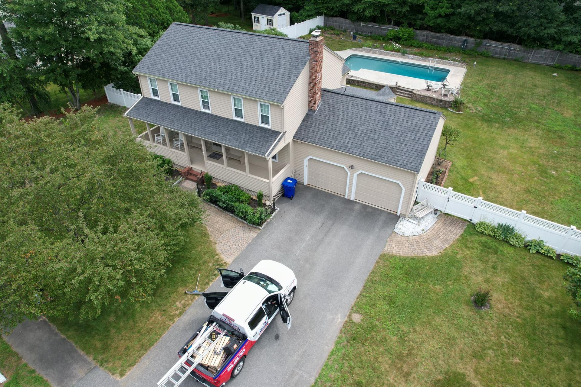 An aerial view of a house with a truck parked in front of it.