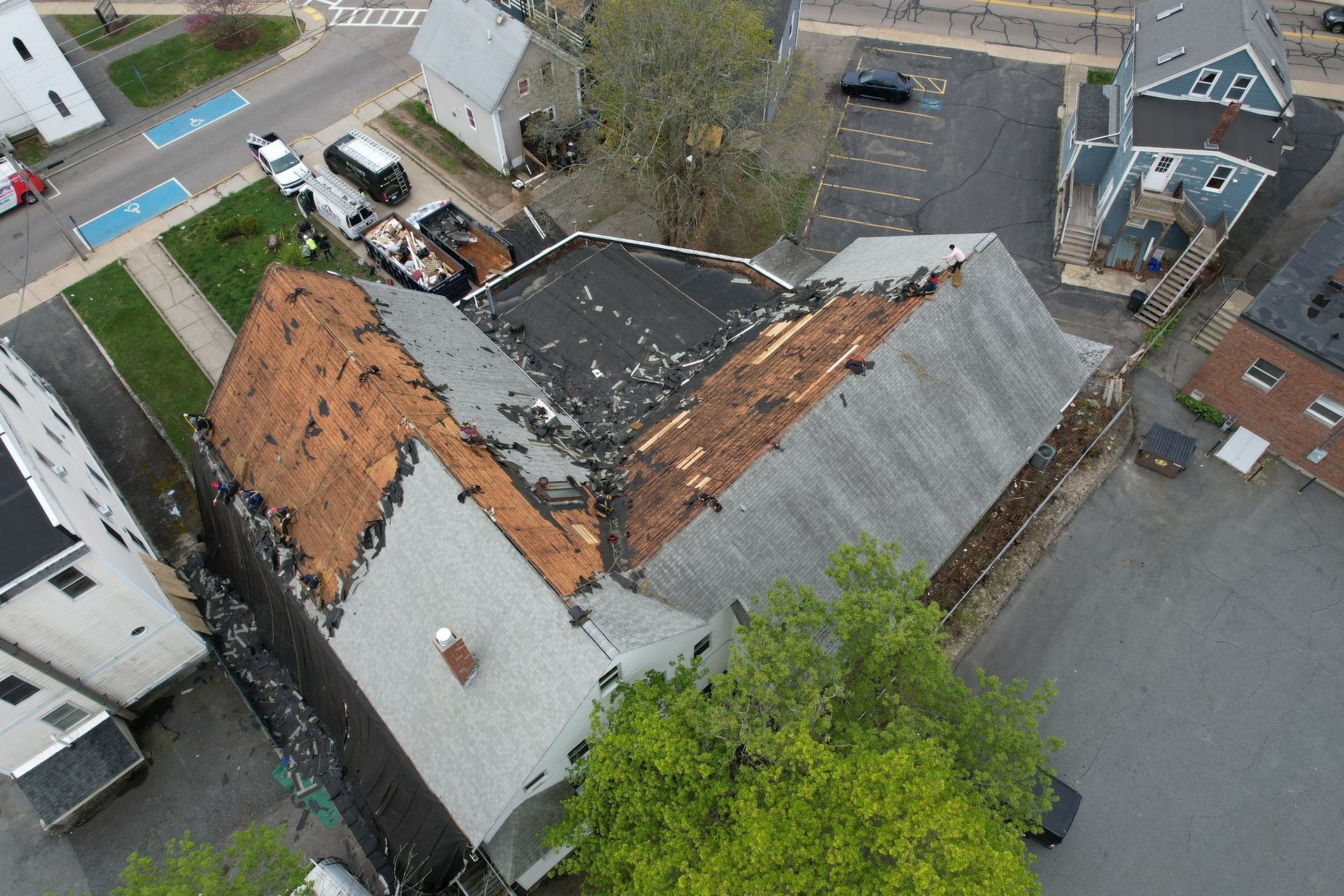 An aerial view of a house with a roof that is being repaired.