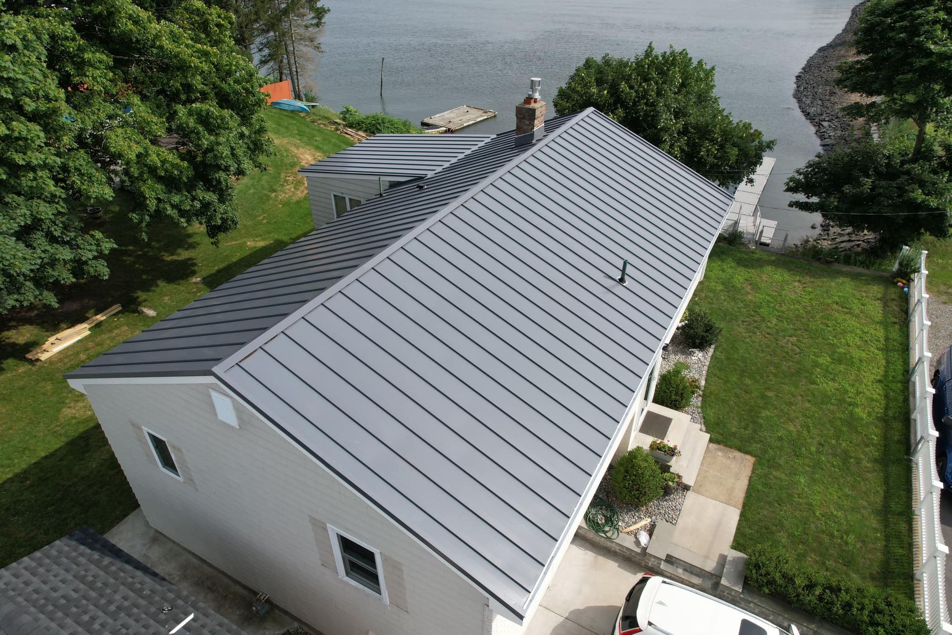 An aerial view of a house with a metal roof.