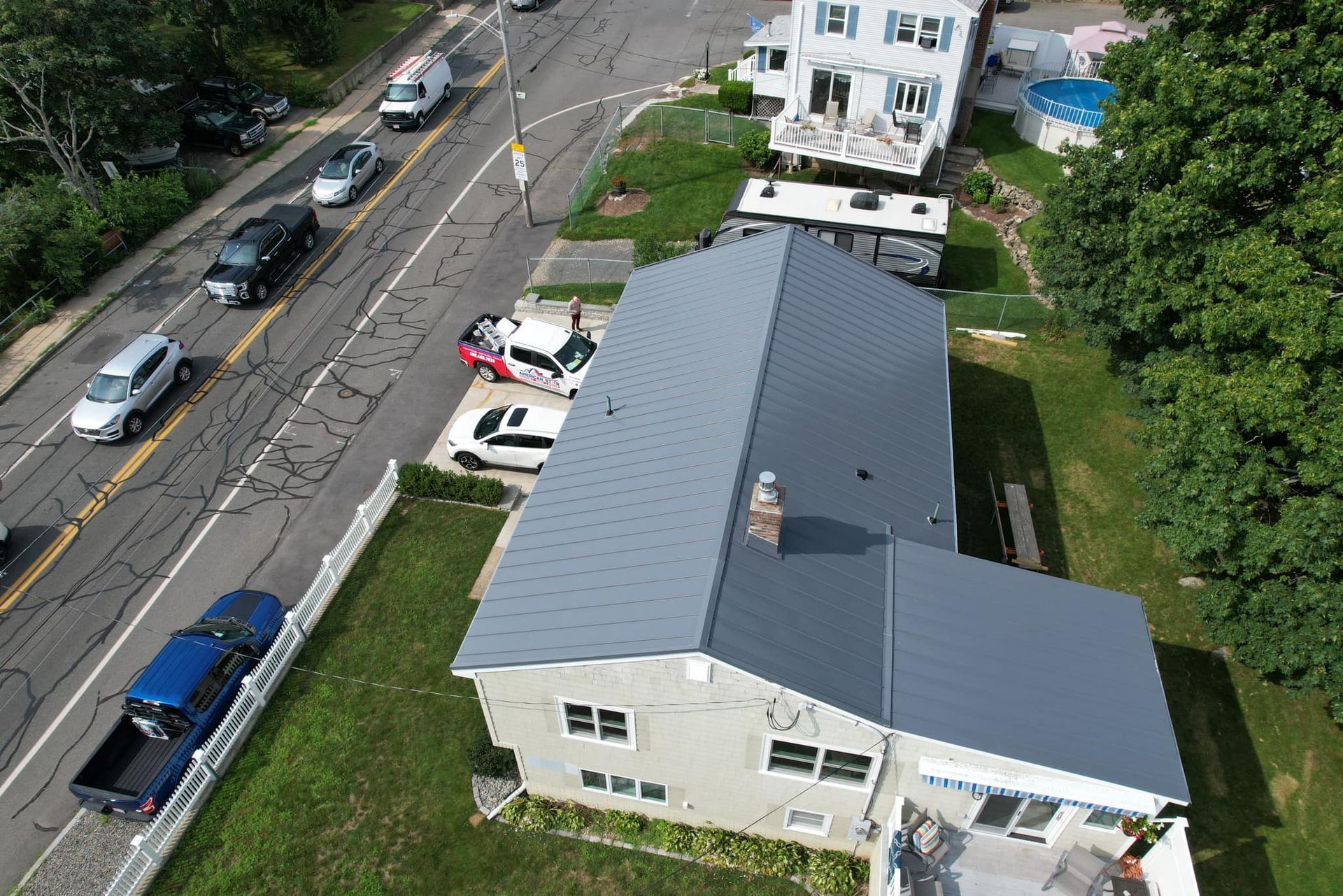 An aerial view of a house with a gray roof