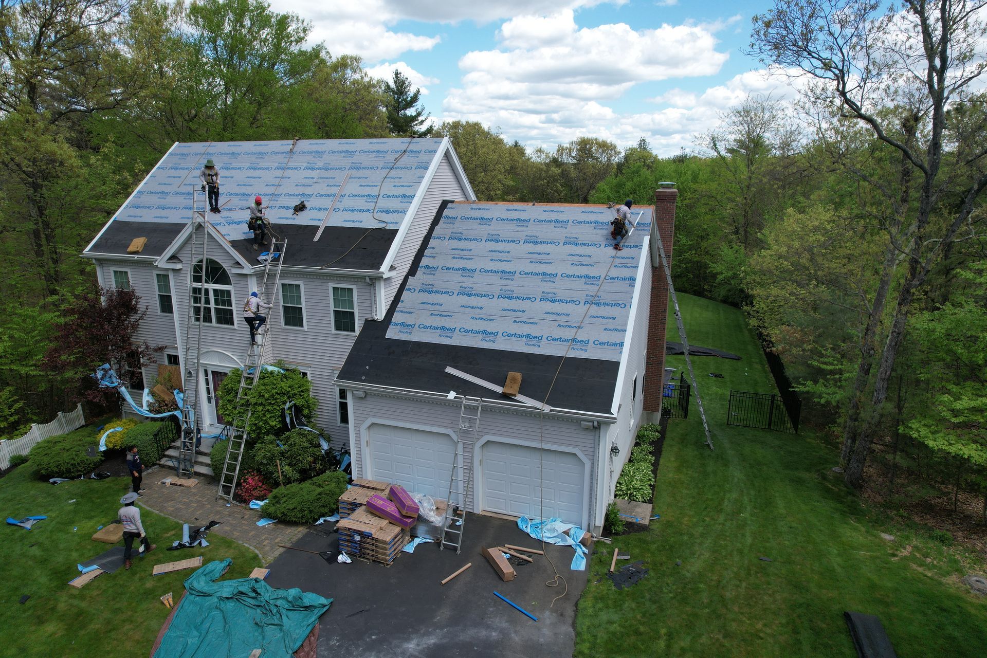 An aerial view of a house being remodeled with a new roof.