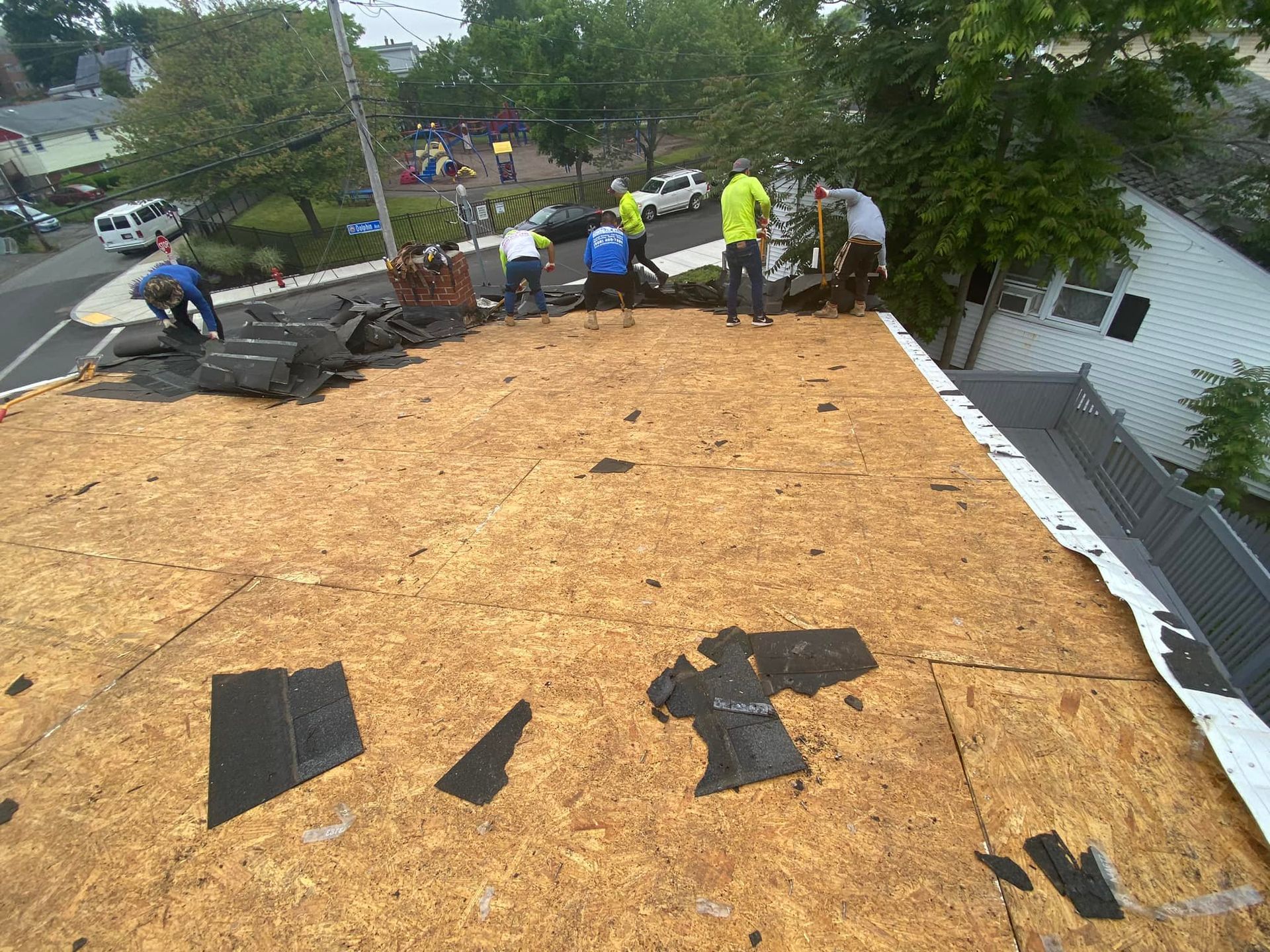 A group of people are working on a roof.