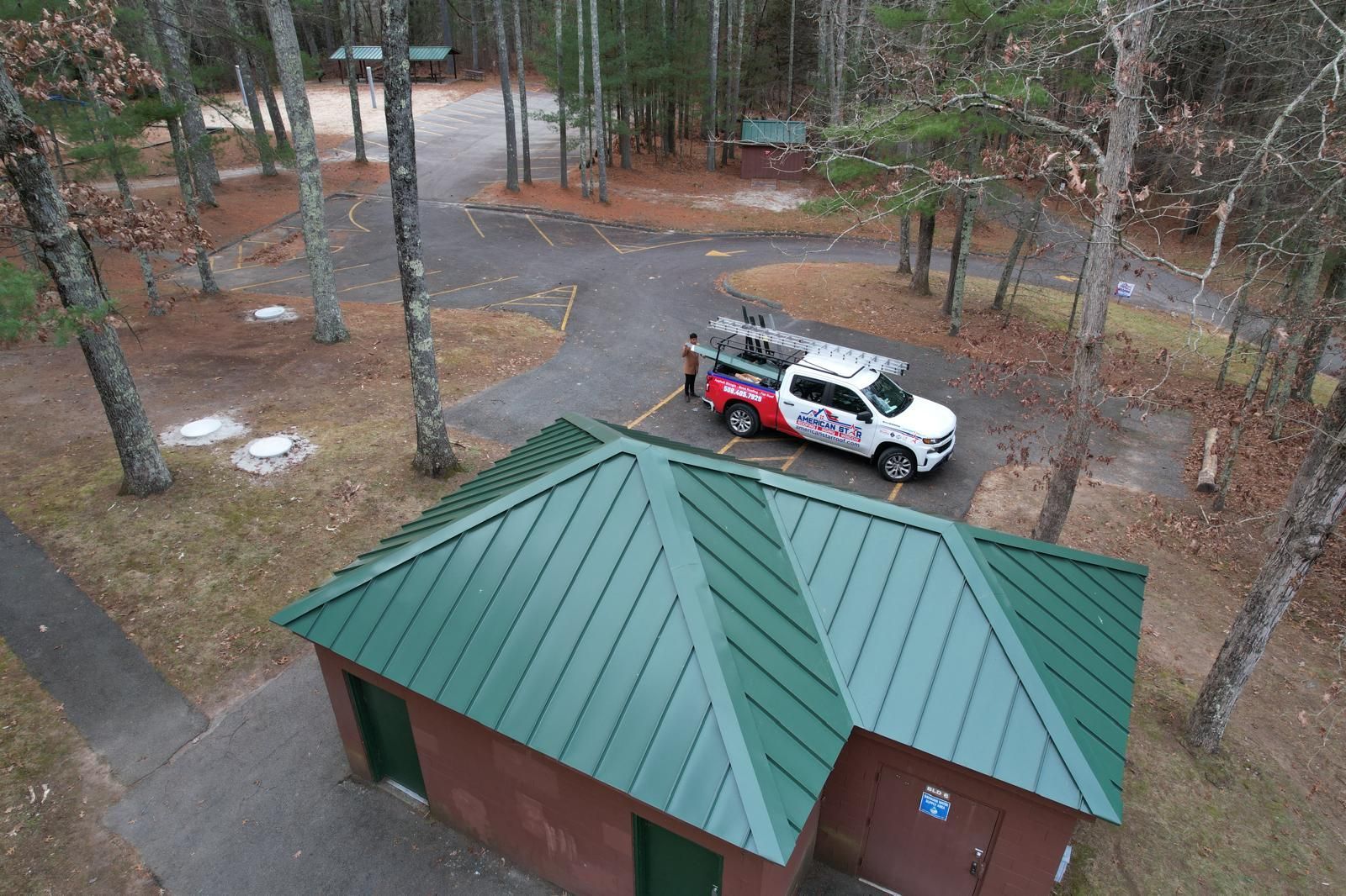 An aerial view of a truck parked on top of a green roof.