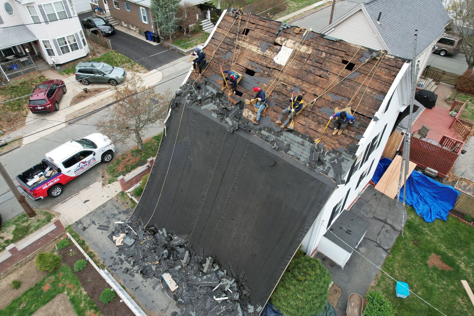 An aerial view of a house with a roof that is being repaired.
