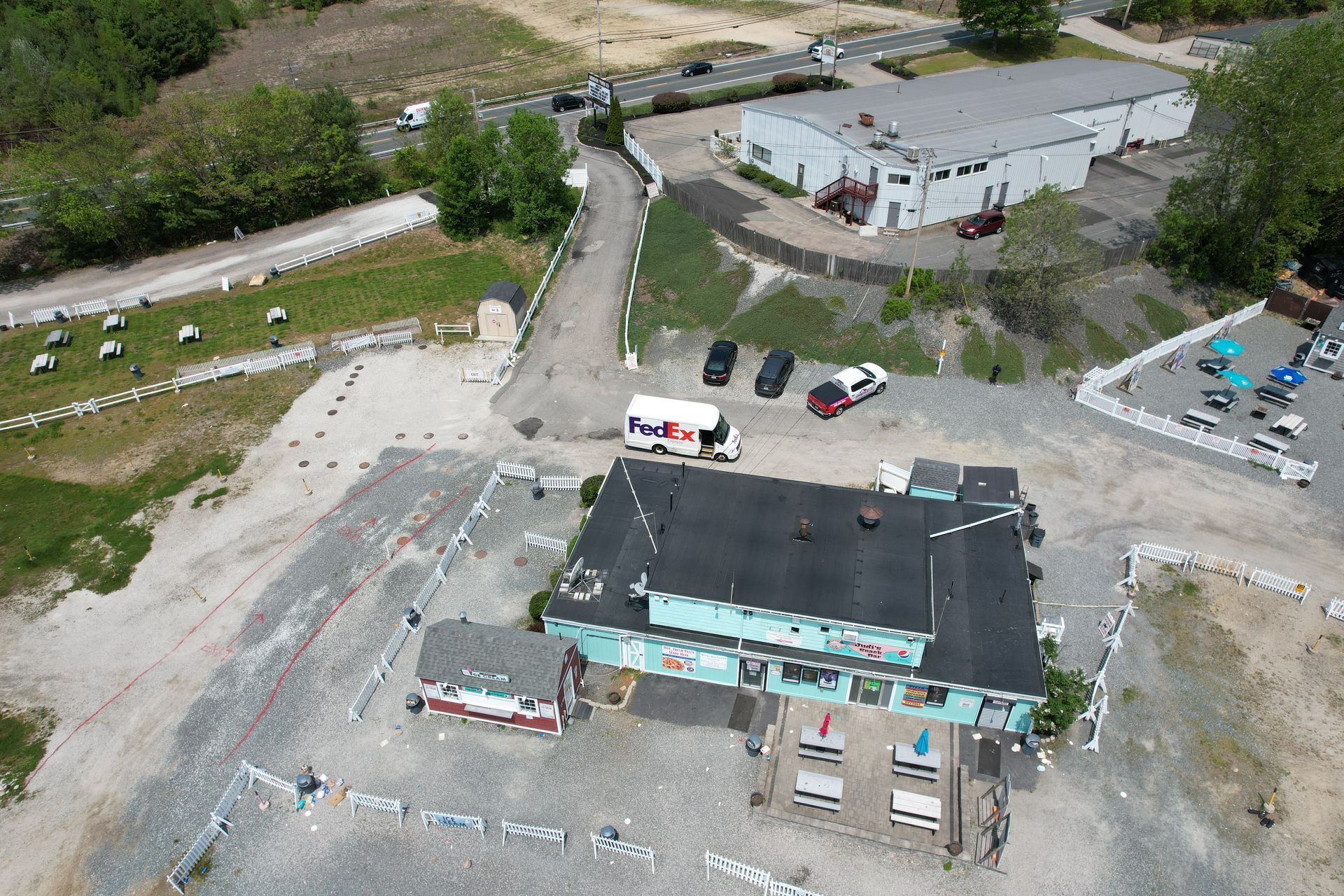 An aerial view of a building with a fedex truck parked in front of it.