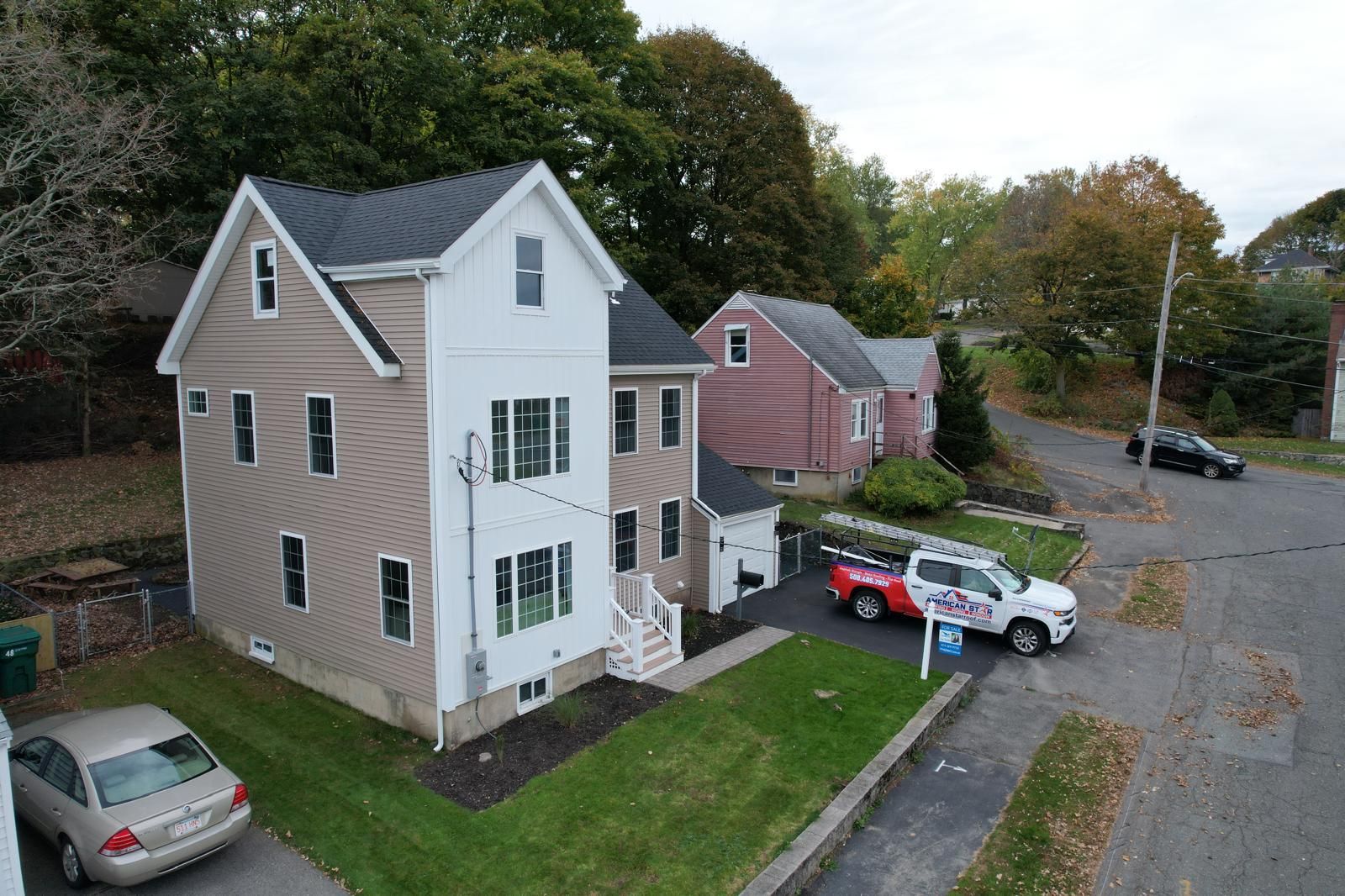 An aerial view of a house with a car parked in front of it.