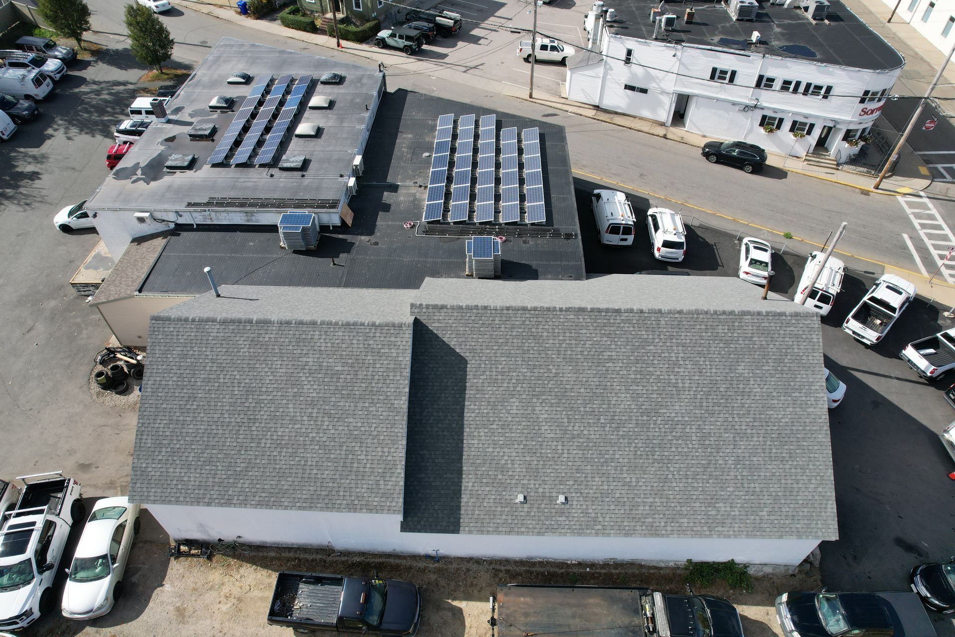 An aerial view of a building with solar panels on the roof