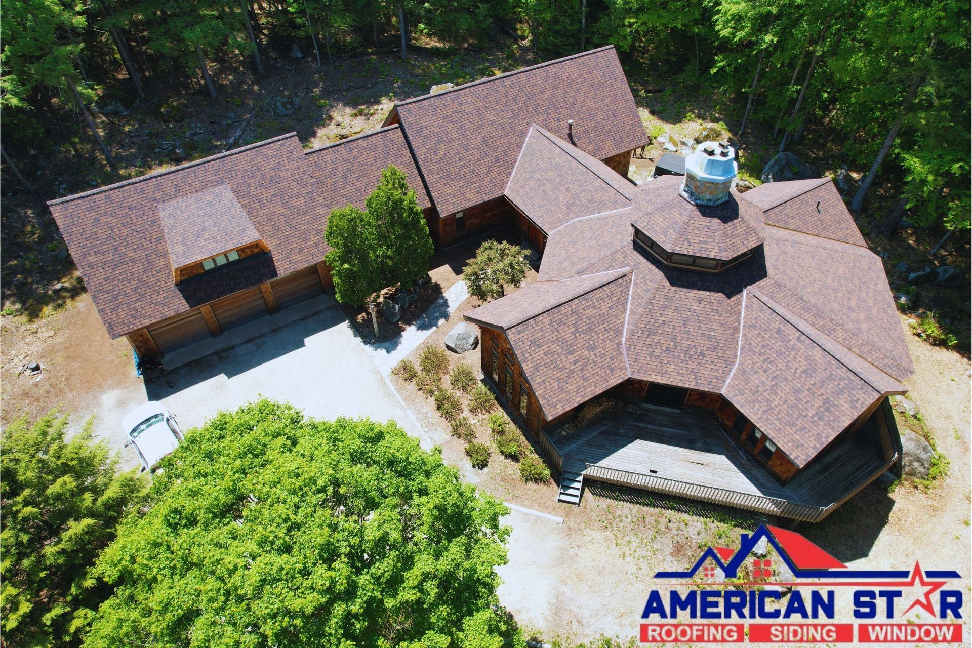 An aerial view of a house with an American Star logo on the roof