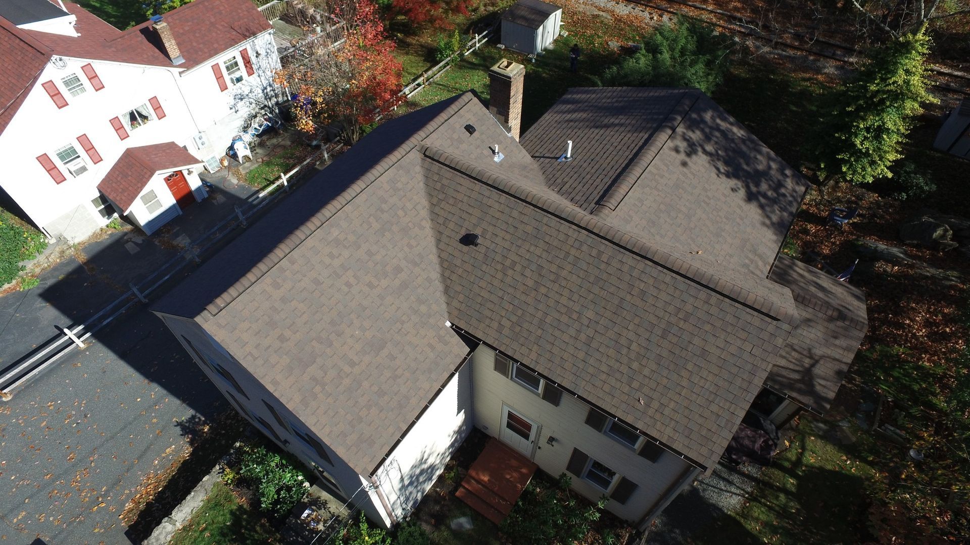 An aerial view of a house with a brown roof
