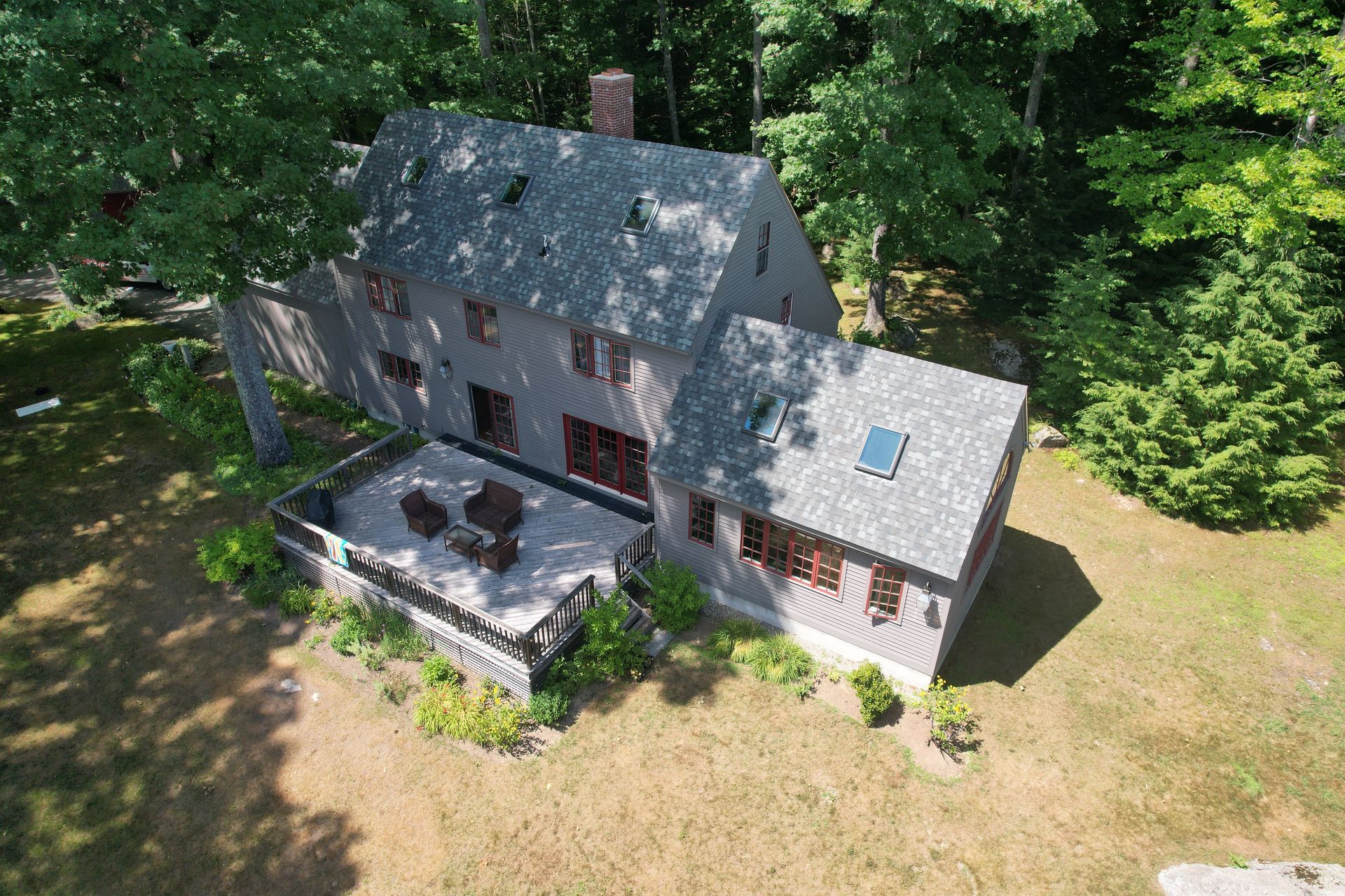 An aerial view of a large house surrounded by trees.