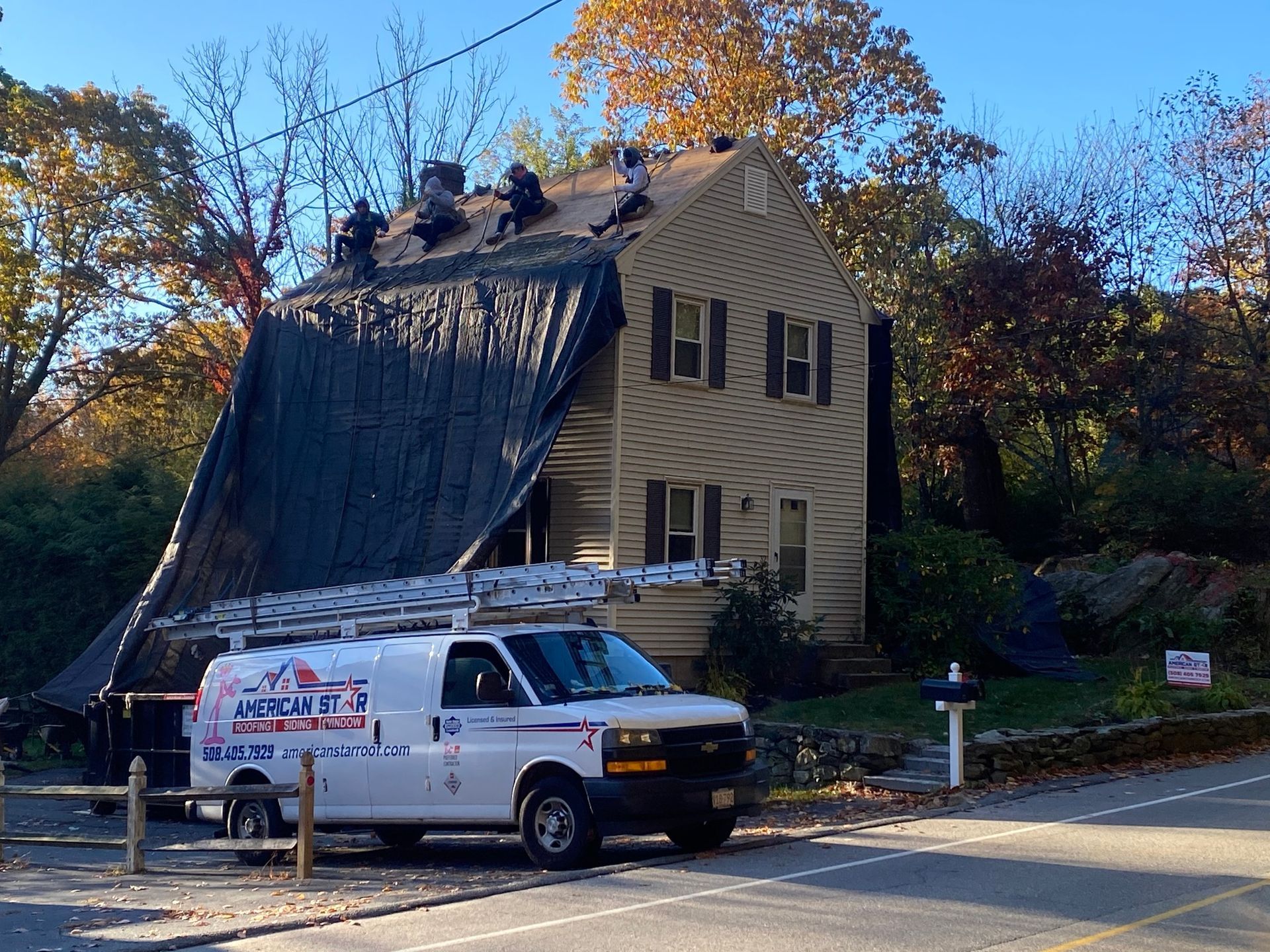 A white van is parked in front of a house that is being remodeled