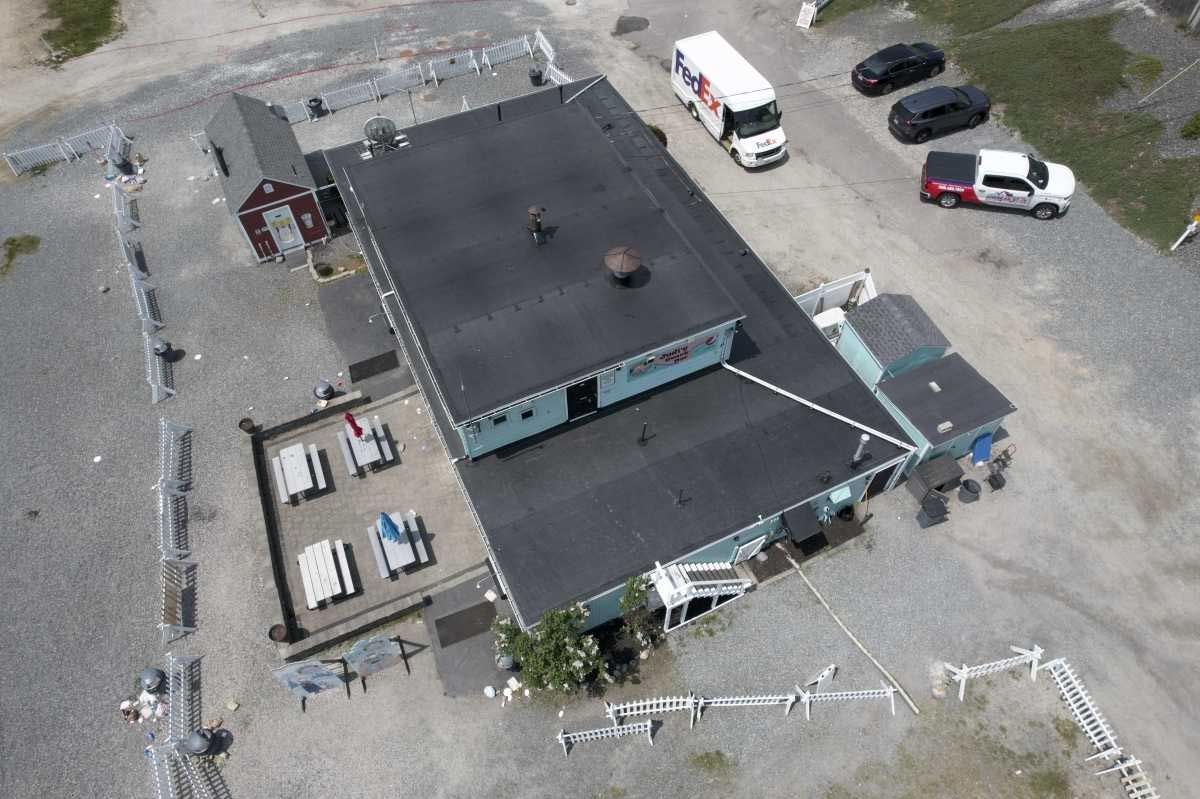 An aerial view of a building with cars parked in front of it