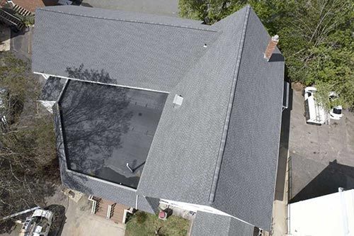 An aerial view of a house with a new roof.