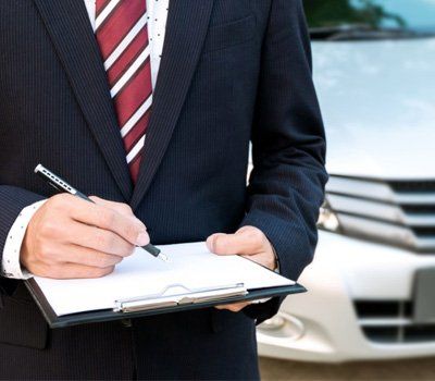An insurance expert employee working with a car at the outdoor