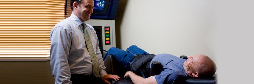 Man lying on a compression machine while smiling