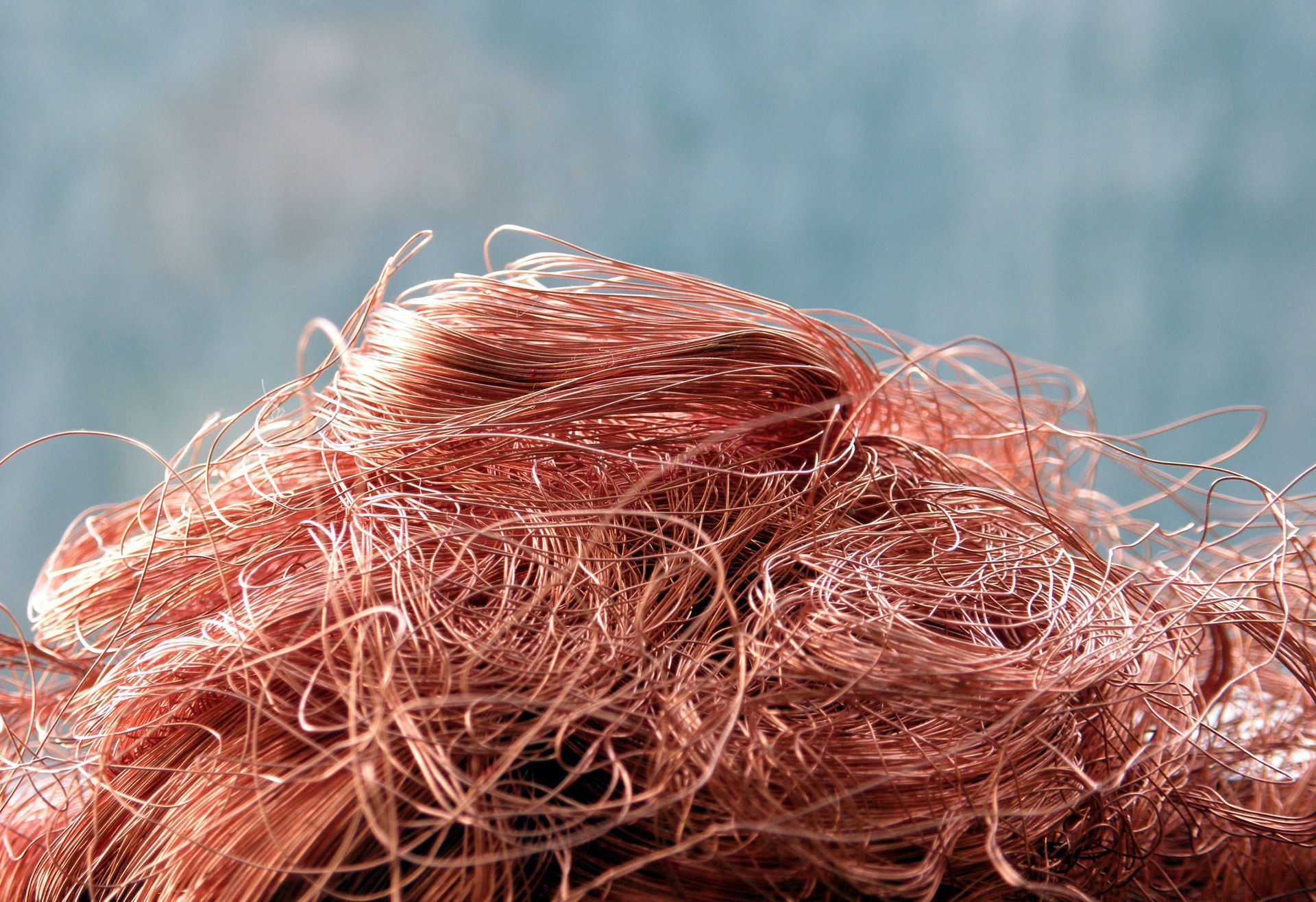 Tangled pile of thin, reddish-brown copper wires.