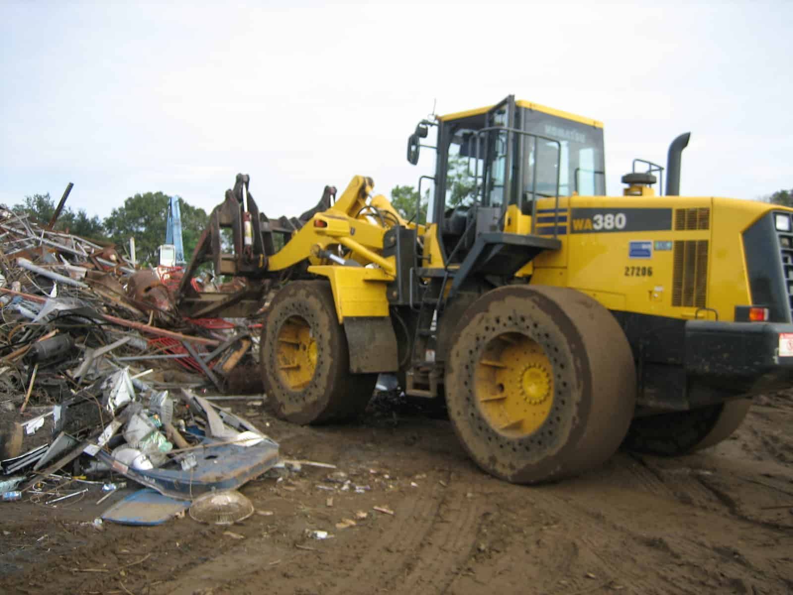 Yellow Komatsu WA380 wheel loader at a scrap metal yard.