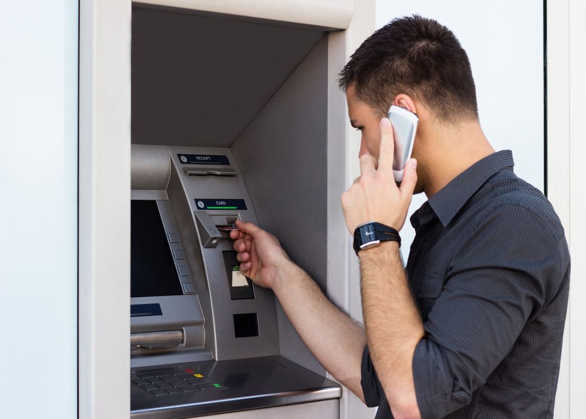 Guy using an ATM machine