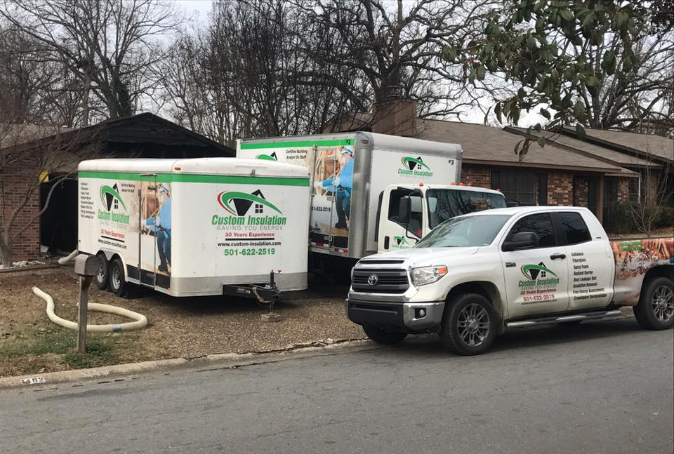Two trucks are parked next to each other on the side of the road.