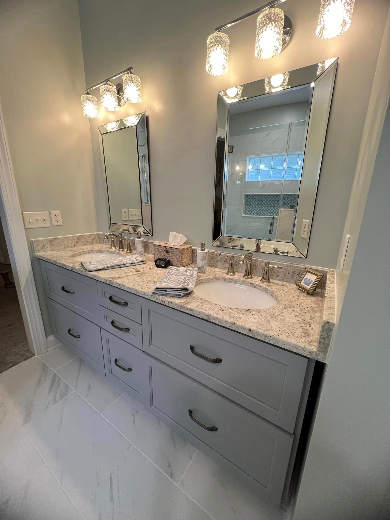 A bathroom with two sinks and two mirrors.