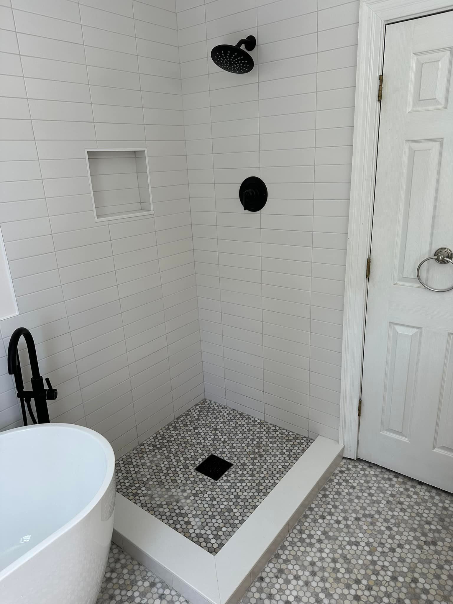 A bathroom with a bathtub and a walk in shower.