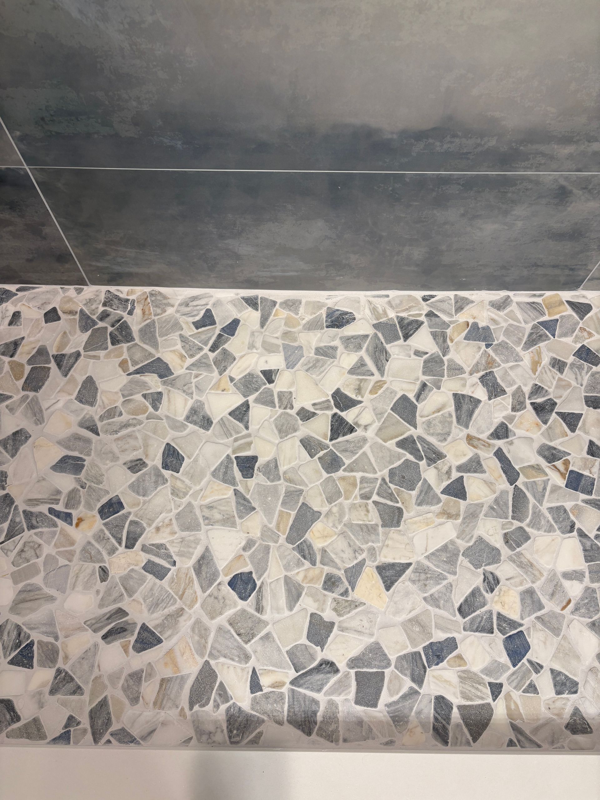 A close up of a tiled floor in a bathroom.